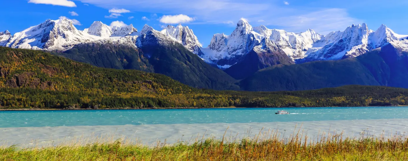 Snow-capped Alaskan mountains above a lake