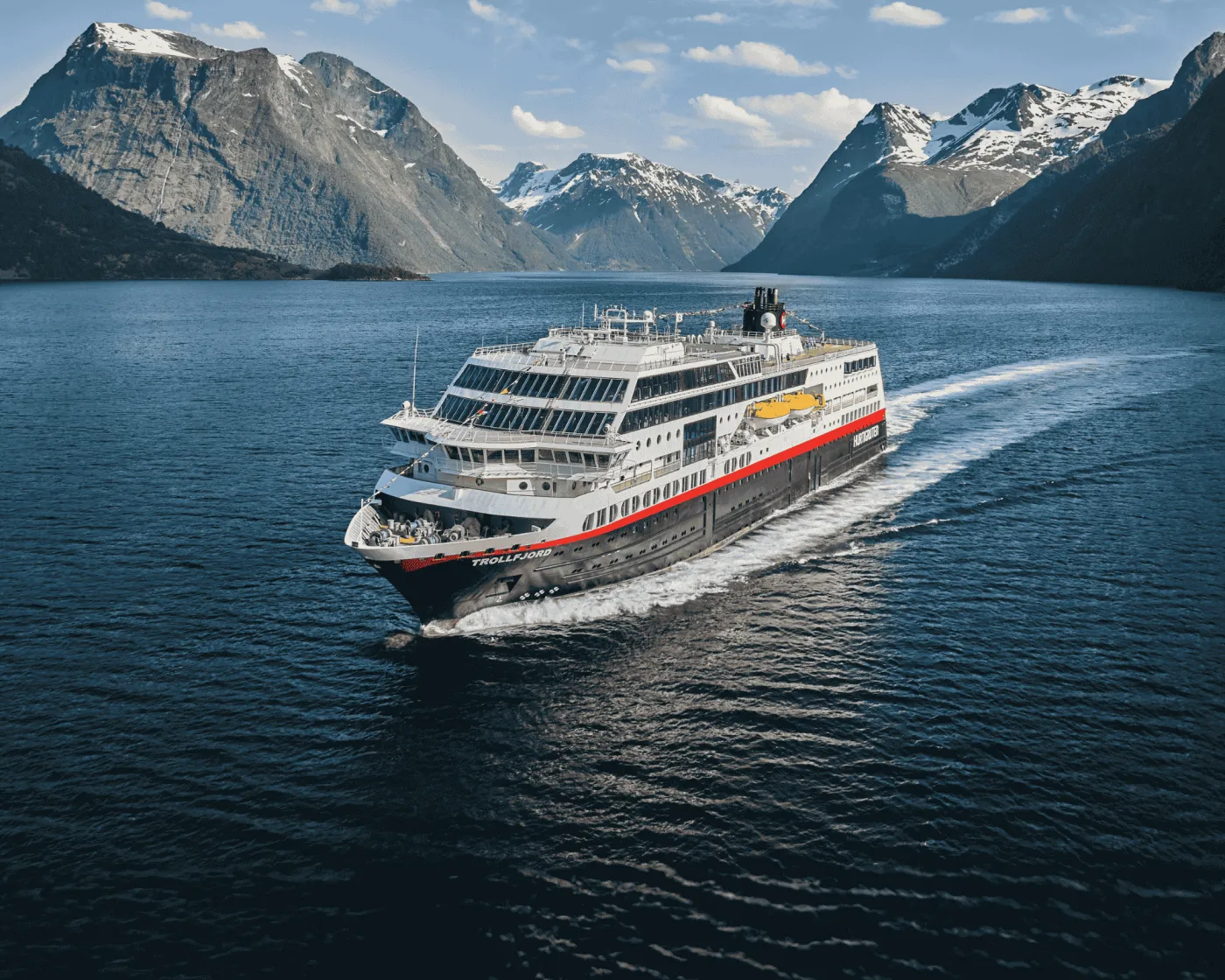 A Hurtigruten ship sailing a Norwegian fjord