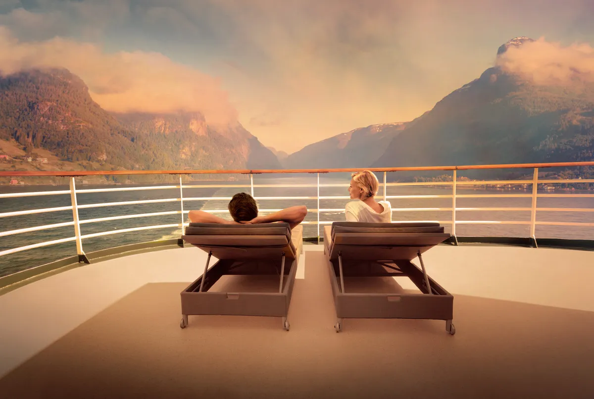 A couple relaxing on loungers on a P&O Cruises deck