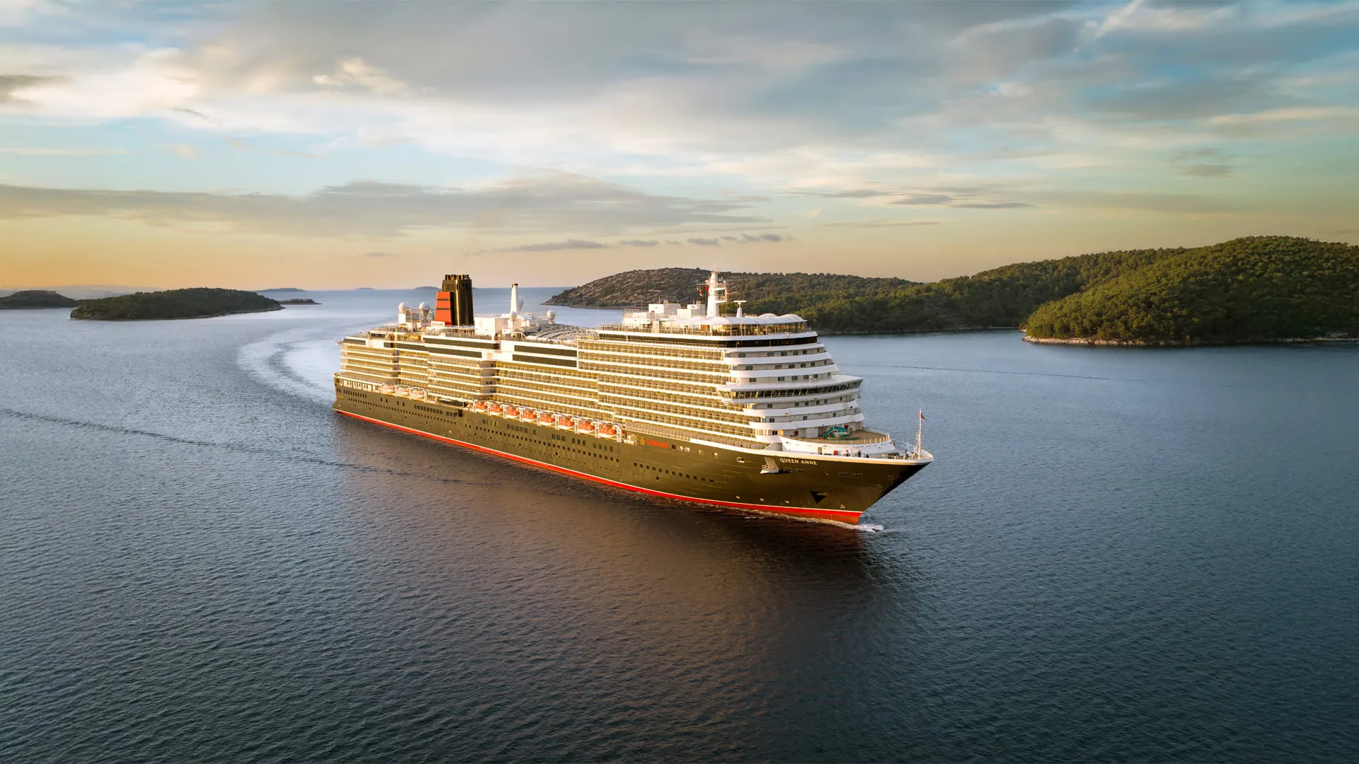 Cunard's Queen Anne at sea in golden evening light