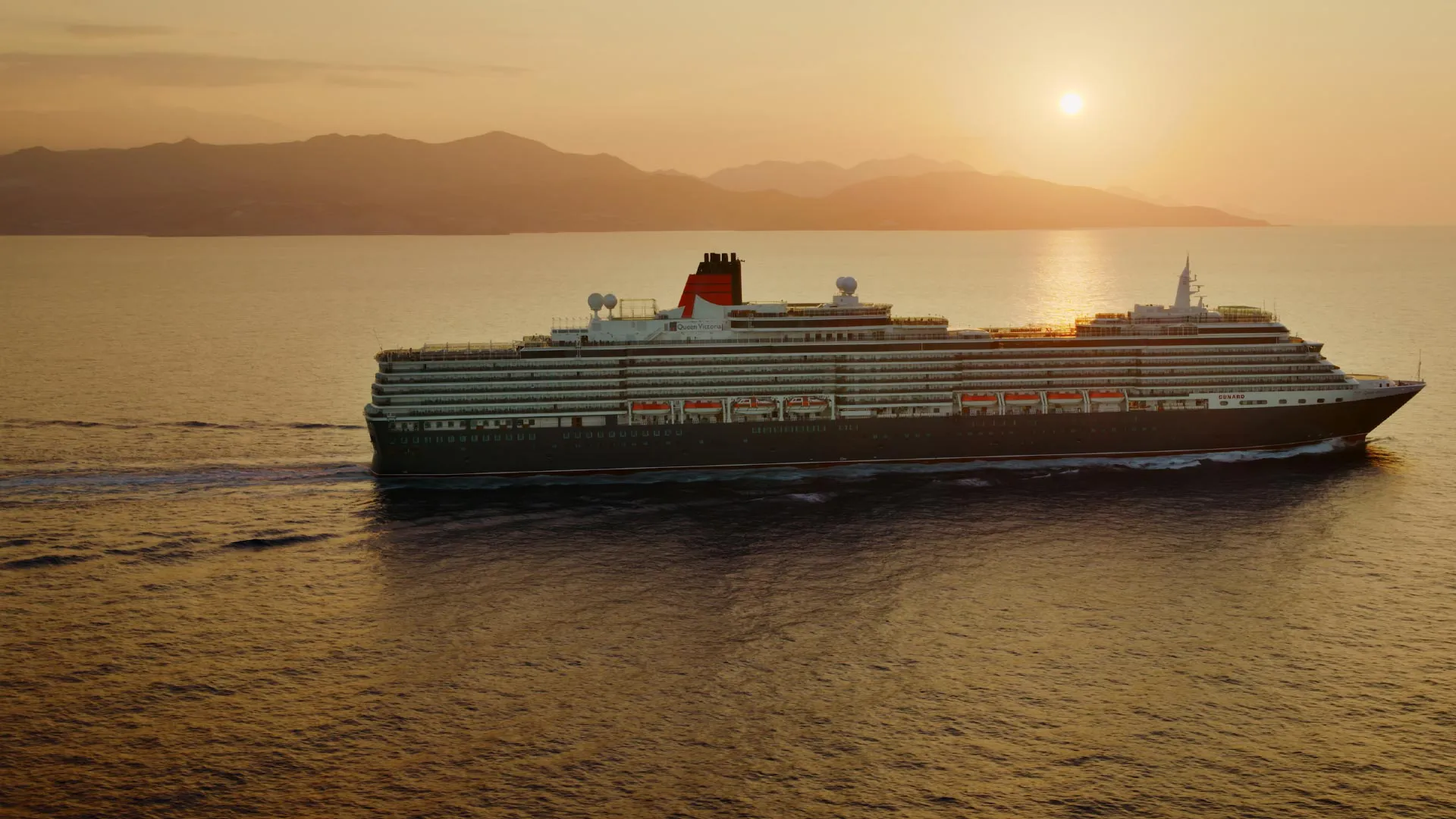 Queen Victoria at sea at sunset