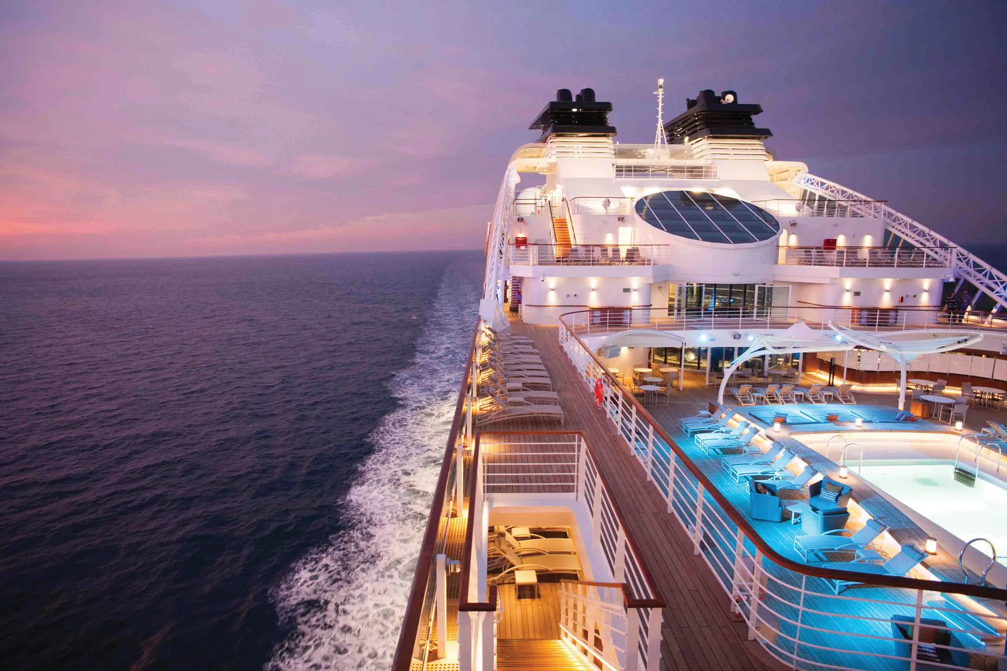 The aft decks and pool of Seabourn Encore at dusk