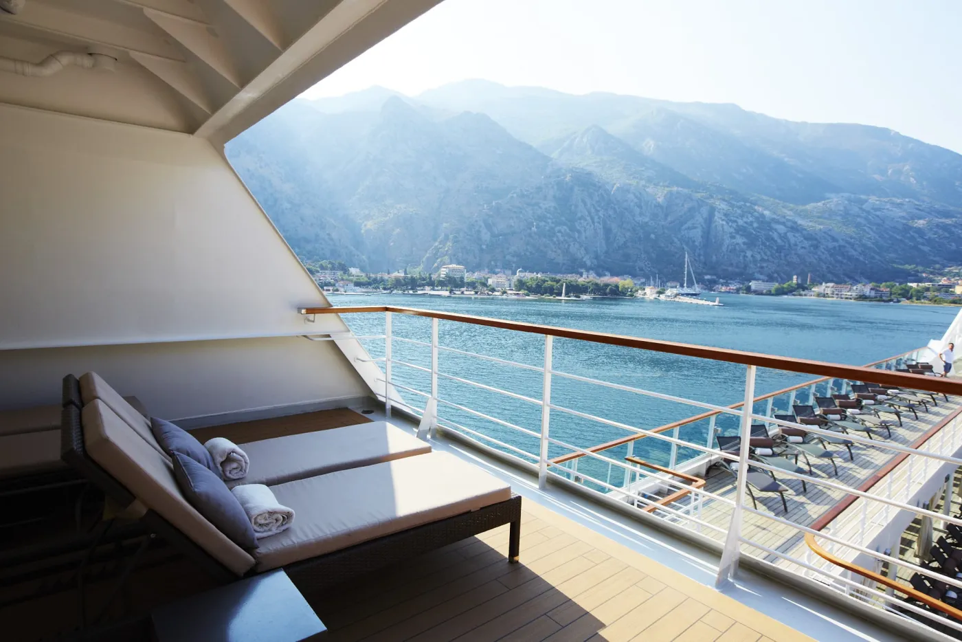 Loungers on a Seabourn patio overlooking a bay