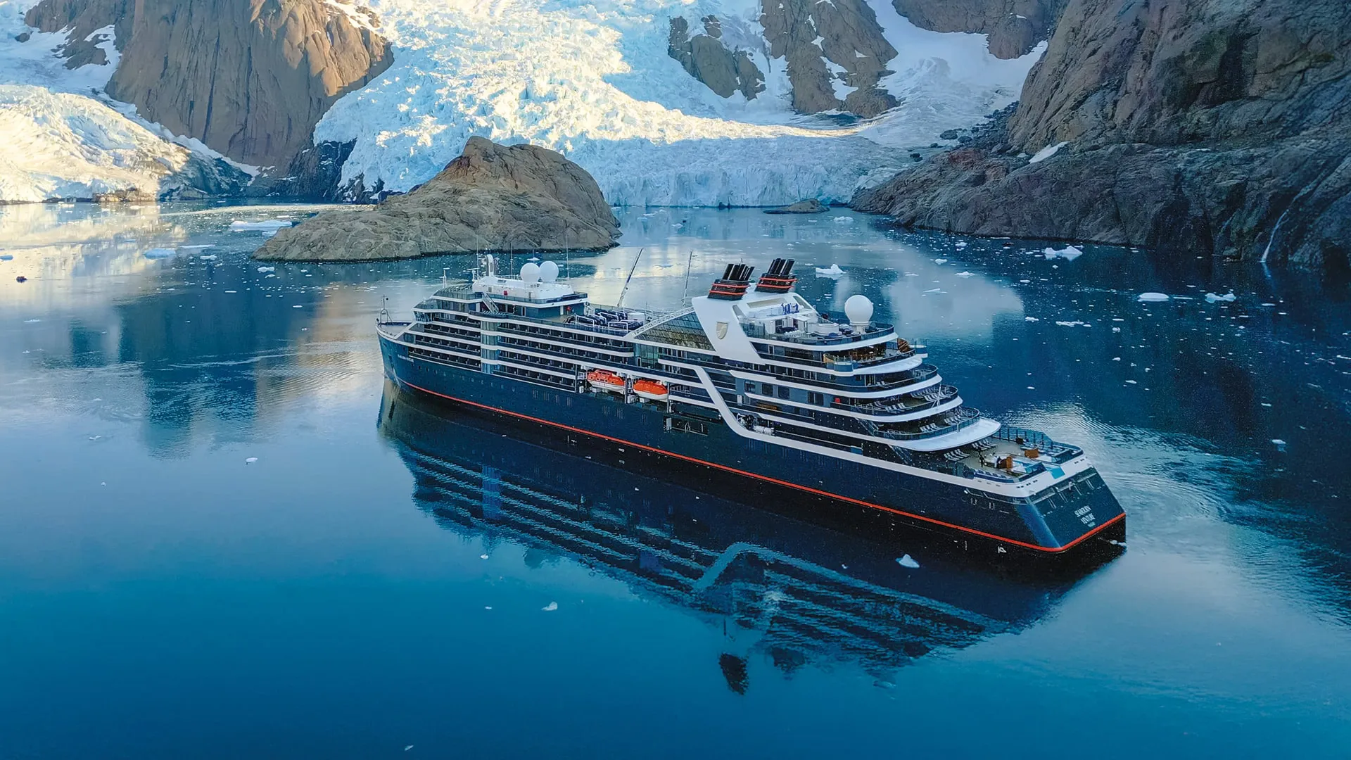 Seabourn's expedition ship beneath a glacier