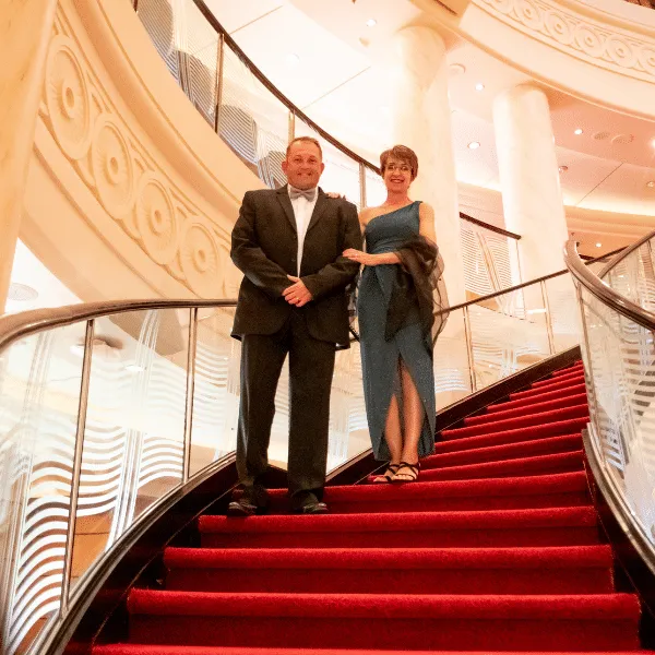 Shaun and Sandy McCarthy on a red staircase on board a ship