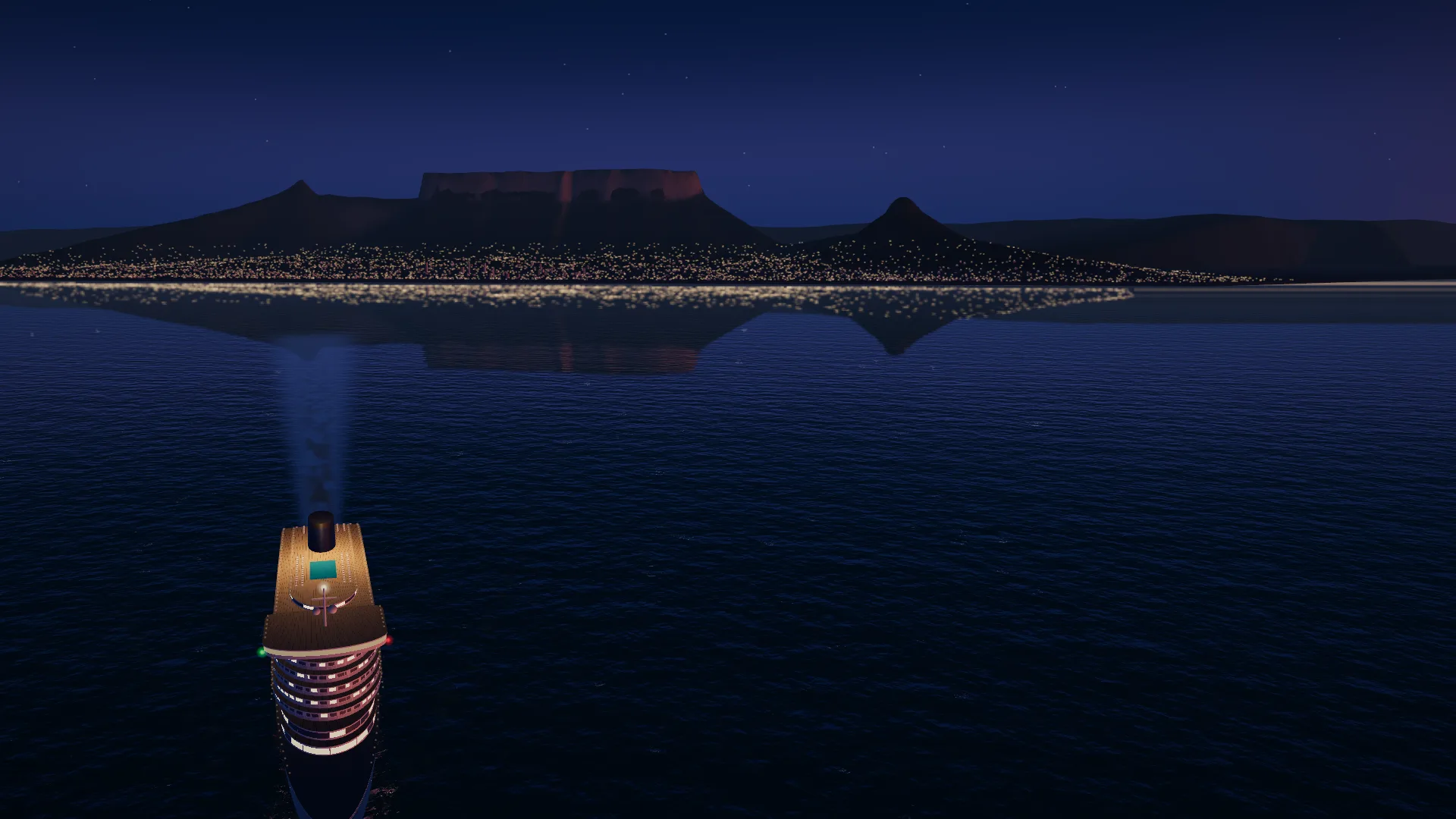 The liner at dusk with its wake drawn out behind it towards Table Mountain and the lights of Cape Town